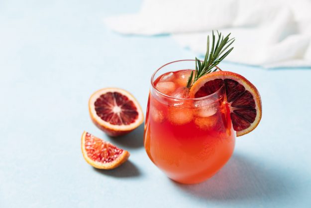 Blood orange holiday mocktail with rosemary sprig