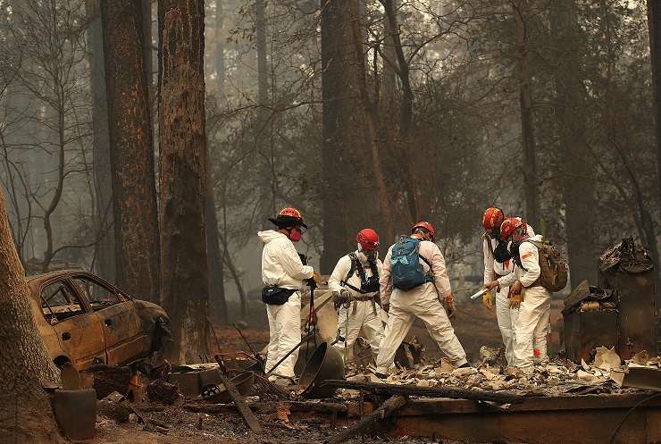 PARADISE, CA - NOVEMBER 15: Rescue workers search for human remains at a home that was burned by th...