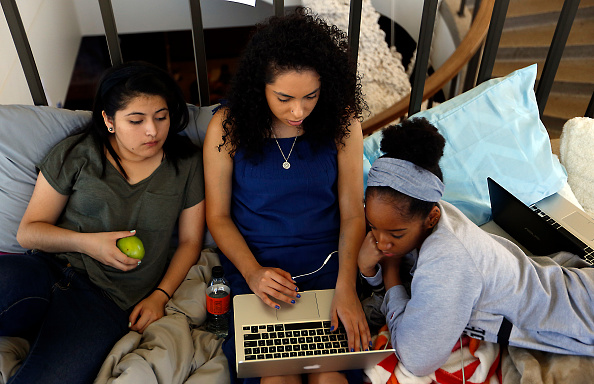 LOS ANGELES, CA - NOVEMBER 19:  Nasira Pratt, 18, right, working on their homework in the lobby of ...