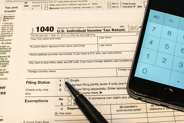 A pen, a smart phone calculator, and Form 1040 tax document.

Photo credit: Stephen Ehlers / Contri...