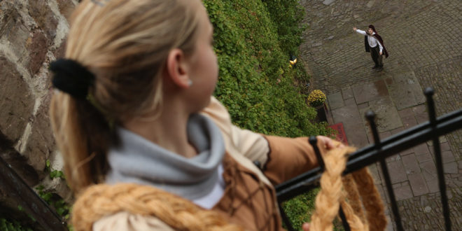 TRENDELBURG, GERMANY - NOVEMBER 18: Rapunzel, actually 13-year-old actress Anna Helver, lets down her hair to her prince, played by actor Daniel Stuebe, from a tower balcony of Trendelburg Castle on November 18, 2012 in Trendelburg, Germany. Rapunzel is one of the many stories featured in the collection of fairy tales collected by the Grimm brothers, and the 200th anniversary of the first publication of the stories will take place this coming December 20th. Anna and another actor perform a skit based on the Rapunzel tale to visitors at Trendelburg Castle, which is now a hotel, every Sunday. The Grimm brothers collected their stories from oral traditions in the region between Frankfurt and Bremen in the early 19th century, and the works include such global classics as Sleeping Beauty, Little Red Riding Hood, The Pied Piper of Hamelin, Cinderella and Hansel and Gretel. (Photo by Sean Gallup/Getty Images)